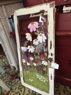 an old door with flowers painted on it