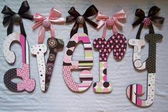 the word joy is made out of wood and decorated with polka dots, bows, and letters