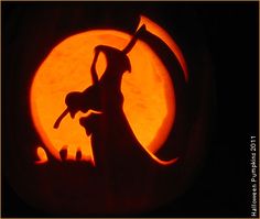 a carved pumpkin with a silhouette of a cat and a person holding a broom in front of a full moon