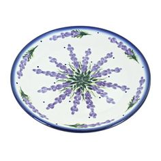 a blue and white plate with purple flowers on it