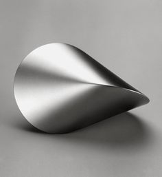 a silver object on a gray surface with no one in the photo to describe it