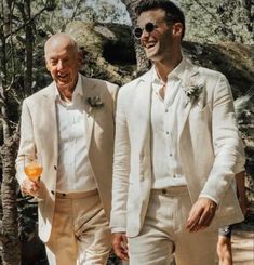 two men in white suits are walking together