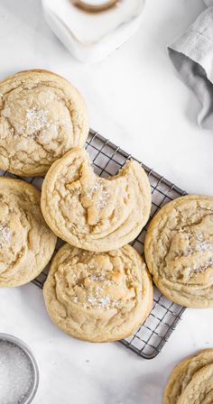 a bunch of cookies sitting on top of a cooling rack