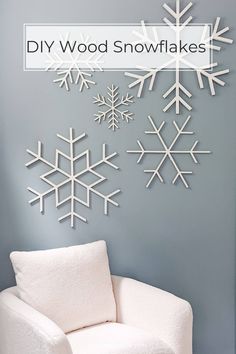 a white chair sitting in front of a wall with snowflakes hanging on it