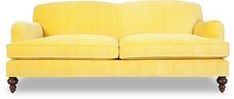 a yellow couch sitting on top of a white floor