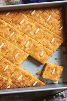 a pan with some food that is cut into squares and placed on top of each other