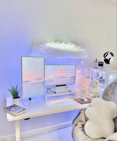 a white desk with two computer monitors and a stuffed animal on it's lap