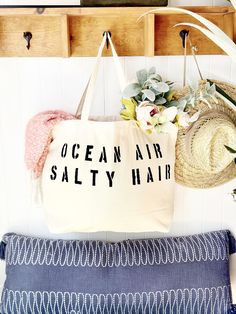 The OCEAN AIR SALTY HAIR over sized canvas tote bag is an eye catching accessory for your relaxing vacation!  It makes a great gift and is perfect for a trip to the grocery store or market, to use as a beach bag, or everyday carryall.  Available with text in several colors... check out the variations!  This bag is made from 100% thick, sturdy canvas. AVAILABLE IN TWO SIZES * Large - 19.5" x 13" with a 4" gusset *Jumbo - 23" x 13" with a 6" gusset   These bags are hand painted using non-toxic fab Trendy Canvas Beach Bag For Beach Season, Trendy Canvas Bag For Beach Season, Summer Large Capacity Cotton Beach Bag, Large Capacity Cotton Beach Bag For Summer, Large Capacity Cotton Bag For Beach Season, Summer Cotton Weekender Bag For Everyday, Cotton Weekender Bag For Everyday Summer Use, Summer Cotton Beach Bag For Travel, Cotton Tote Bag For Vacation