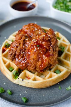 fried chicken and waffles on a plate with sauce