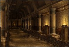 the interior of an old building with columns and pillars in it, lit by candles