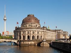 a large building sitting on the side of a river