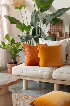 a living room filled with lots of furniture and plants on top of the couches