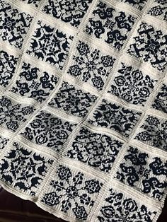 a black and white quilt sitting on top of a table