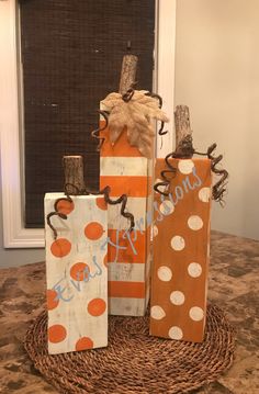 three orange and white paper bags sitting on top of a table next to each other