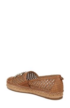 An espadrille-inspired flat features a breezy latticed design highlighted by a woven cap toe, gleaming logo hardware and earthy jute trim. 1" heel Textile upper/leather lining/synthetic sole Imported Spring Woven Leather Flats With Round Toe, Spring Slip-on Woven Leather Flats, Casual Woven Leather Espadrilles With Round Toe, Casual Leather Espadrilles With Woven Detail, Casual Woven Leather Espadrilles, Woven Leather Round Toe Espadrilles, Woven Leather Espadrilles With Round Toe, Espadrille Flats With Woven Sole, Closed Toe Woven Leather Espadrilles