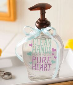 a soap dispenser sitting on top of a counter with a blue ribbon around it