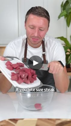 a man holding a plate with meat on it