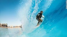 a man riding a wave on top of a surfboard