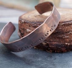 Hand forged from rich jewelers copper, this cuff is a simple, rustic statement piece. Cuffs are hammered and hand stamped with the Latitude Longitude coordinates of your choice. Popular locations are first kiss, wedding, birthplace of child, etc.  The cuff is oxidized in an organic solution to give it a rich, warm patina and bring out the details. Each cuff is 1/2" wide and 6" in length.Please leave us your coordinates in the DMS format.You can get the DMS Lat/Long coordinates of your location a Rustic Stamped Cuff Bracelet Gift, Stamped Copper Cuff Bracelet As Gift, Stamped Copper Cuff Bracelet For Gift, First Kiss Wedding, Kiss Wedding, 22nd Anniversary, Coordinates Bracelet, Copper Gifts, Latitude Longitude