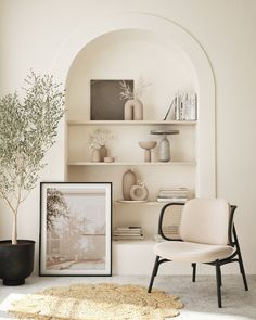 a living room filled with furniture and a potted plant on top of a table