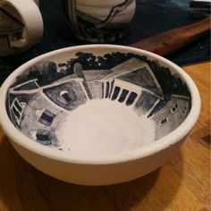 a white bowl sitting on top of a wooden table