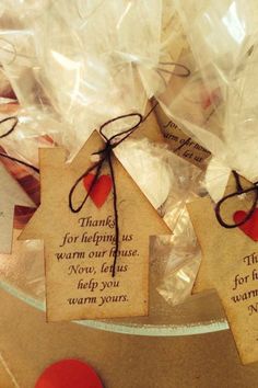 small tags with words on them sitting on a glass plate next to an orange and red apple