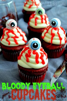 red cupcakes with white frosting and eyes on top