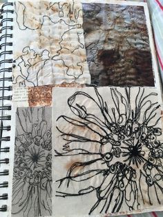 a spiral notebook covered in different types of paper and ink drawings on top of each other