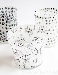 three black and white patterned cups with the words tissue paper lanterns in front of them