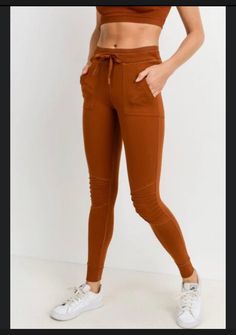 Moisture wicking. Four-way stretch. Casual High-stretch Joggers For Sports, High Stretch Casual Joggers For Sports, Casual High Stretch Orange Activewear, Orange Stretch Casual Activewear, Casual Orange Stretch Activewear, Stretch Activewear For Jogging In Fall, Fall Stretch Activewear For Jogging, Sporty Brown Joggers For Fall, Fall Sporty Brown Joggers