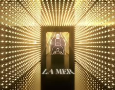 the entrance to la mer is lit up with white lights and starbursts