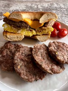 a plate with hamburgers and tomatoes on it