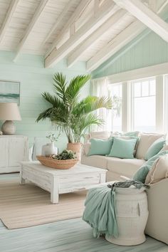 a living room filled with furniture and a potted plant on top of a table