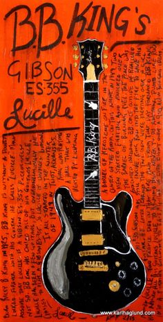 an orange and black guitar with writing on it's back side, in the background is