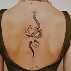 a woman with a snake tattoo on her back