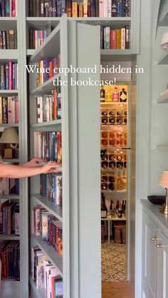 a woman standing in front of a book shelf filled with lots of books on it