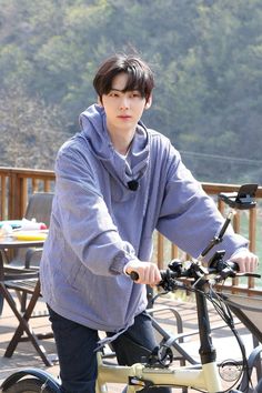 a young man is riding his bike on the deck