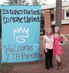 two women standing in front of a sign that says it takes the best to make the best