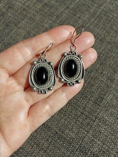 Beautiful vintage handmade Navajo tribe dangle earrings, possibly from the 80's-90's *Beautiful detailing  *Large beautiful black Onyx cabochons  *1-3/4" long approx. including hook *Singed by artist AB *Weight: 11.7 grams. *Great vtg condition, nice patina & normal wear, no cracks, stones are well secured. ALL SALES ARE FINAL, FEEL FREE TO ASK BEFORE PURCHASING  ;)) FOLLOW ME ON IG FOR SHOP SALES AND PREVIEWS  @MYSTIKBAZAARSHOP THANK YOU SO MUCH FOR VISITING Hoop Dangle Earrings, Indie Jewelry, Funky Jewelry, Etsy Earrings Dangle, Black Onyx, Jewelry Earrings Dangle, Native American, Onyx, Patina