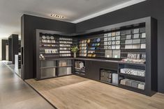 an empty room with many books and magazines on the shelves, along with other items