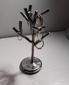 a small metal tree with rings on it