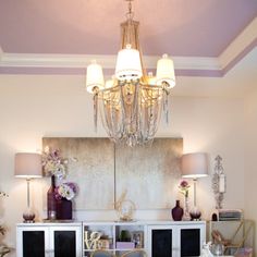 a living room with a chandelier hanging from the ceiling