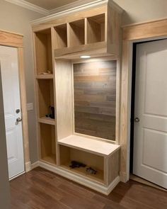 an empty room with wooden shelves and doors