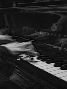 a black and white photo of a piano