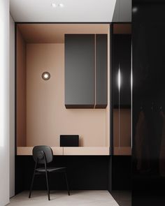 a chair sitting in front of a black cabinet and white wall with lights on it