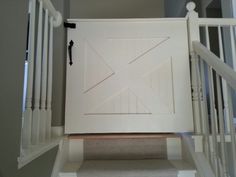 an open white door on the side of a staircase leading up to a second story