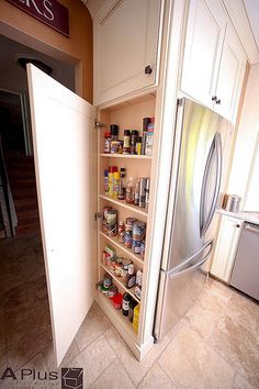 a kitchen with a refrigerator and pantry in it