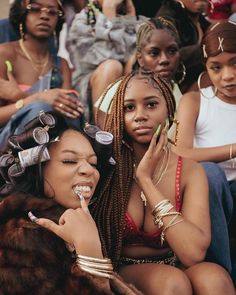 two women sitting next to each other in front of a group of people with glasses on their heads