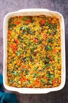 a casserole dish with vegetables and meat in it on a marble countertop