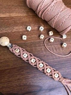 a spool of thread and some beads on a table